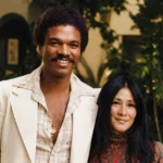 Teruko Nakagami in a vintage-style portrait standing beside a smiling man outdoors